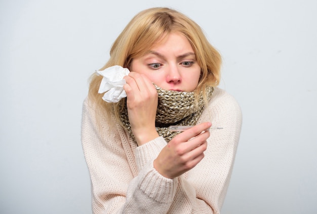 Measure temperature. Break fever remedies. Seasonal flu concept. Woman feels badly. How to bring fever down. Fever symptoms and causes. Sick girl with fever. Girl sick hold thermometer and tissue.