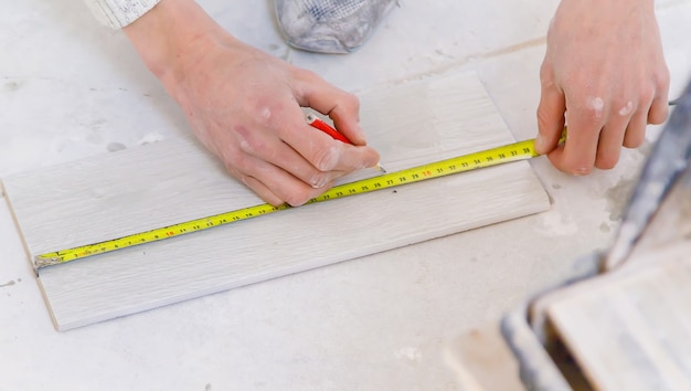 Measure tile repair in the house. selective focus.