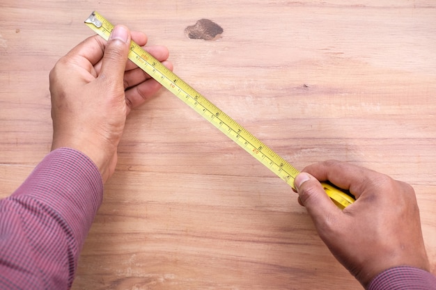 Photo measurements on a wood with a tape measure tools.