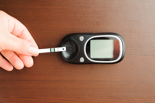 Photo measuring blood sugar with a blood glucose meter.