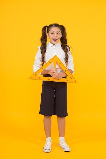 Measuring equipment. Kid cute school student study mathematics. Triangle right angle. Knowledge day. Schoolgirl school uniform hold big ruler geometry school lesson. Math stem architecture faculty.