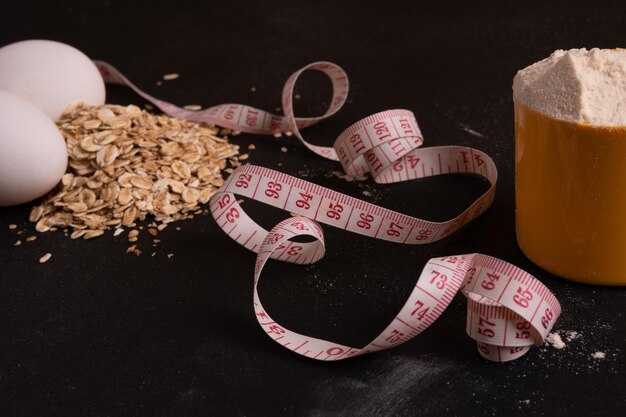 Measuring tape on a black background The concept of weight loss or weight gain Space for text