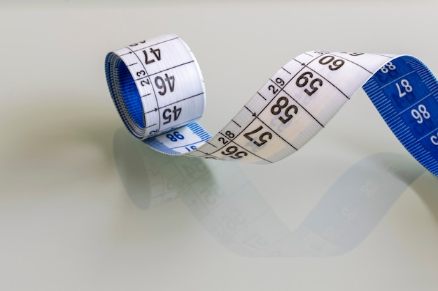 Measuring tape draped over the glass table.