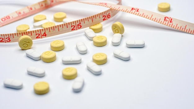 Measuring tape and pills for dieting concept medical health care and prevention