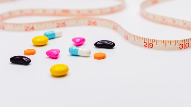 Measuring tape and pills for dieting concept medical health care and prevention