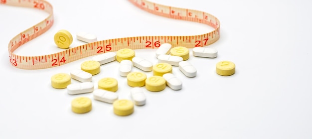 Measuring tape and pills for dieting concept medical health care and prevention