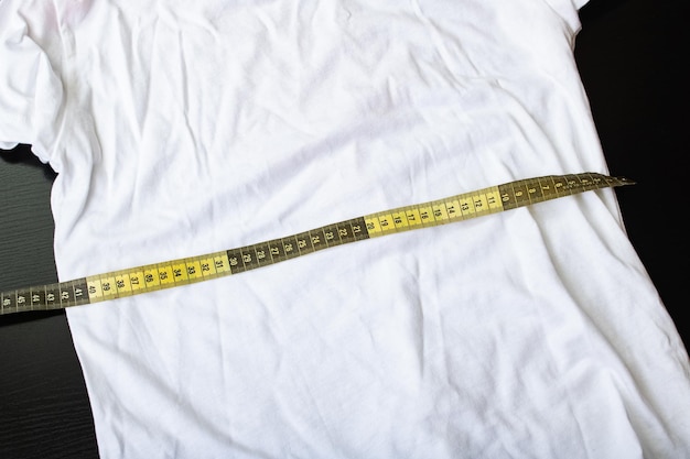 Photo measuring tape on white fabric close up