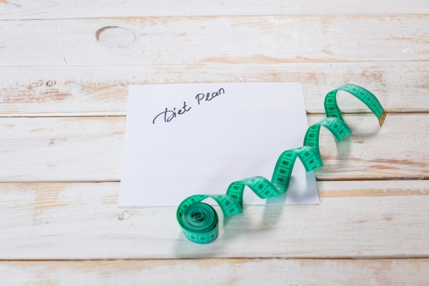 Measuring tape on a wooden surface, diet concept