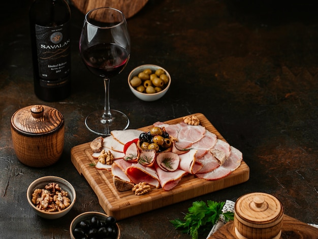 Meat appetizer on a plate on old wooden background