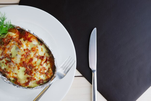 Meat baked in foil with vegetables and cheese