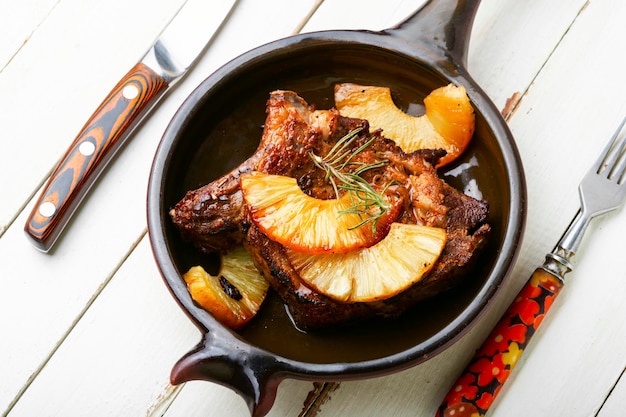 Photo meat baked with pineapple rings