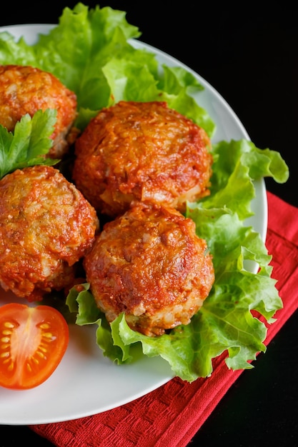 Meat balls in tomato sauce on a black background Homemade protein meal for healthy eating