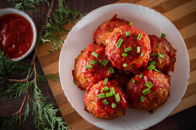 Meat balls with tomato sauce and herbs