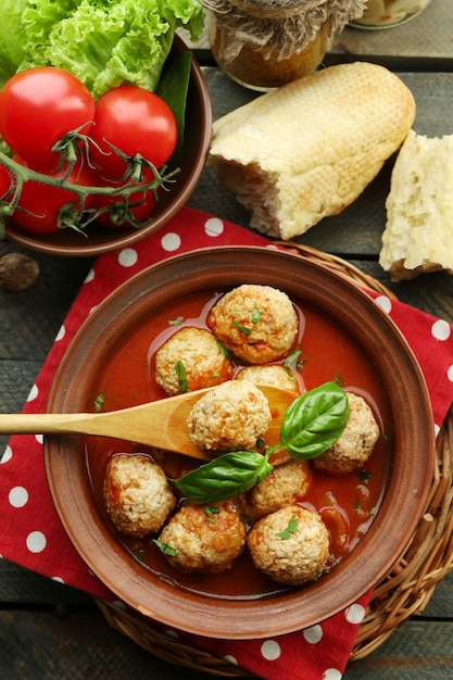 Meat balls with tomato sauce wooden spoon on wooden background