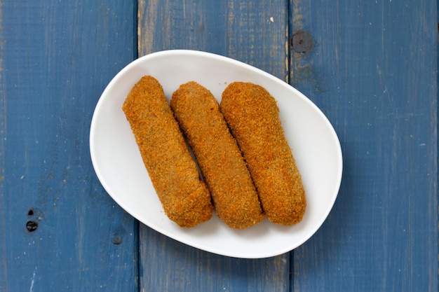 Meat croquete on white plate