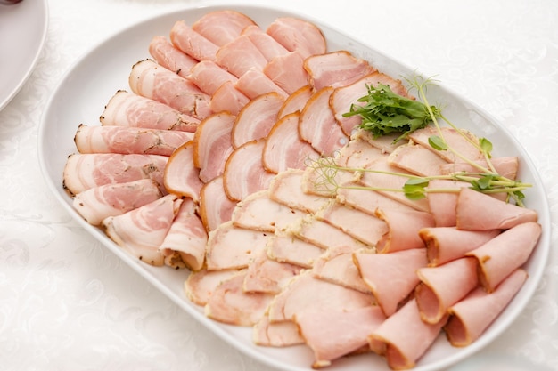 Meat cutting and its presentation on the festive table ham meat appetizer