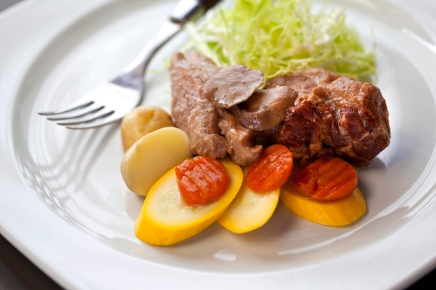 Photo meat dish carrots potatoes and zucchini