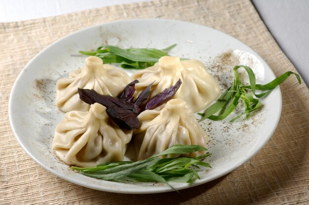 Meat dumplings served on green plate with vegetables