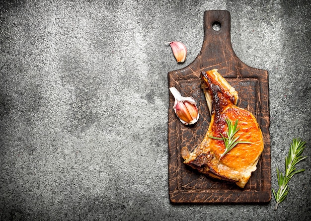 Meat grill. Fried piece of meat with spices on a rustic background.