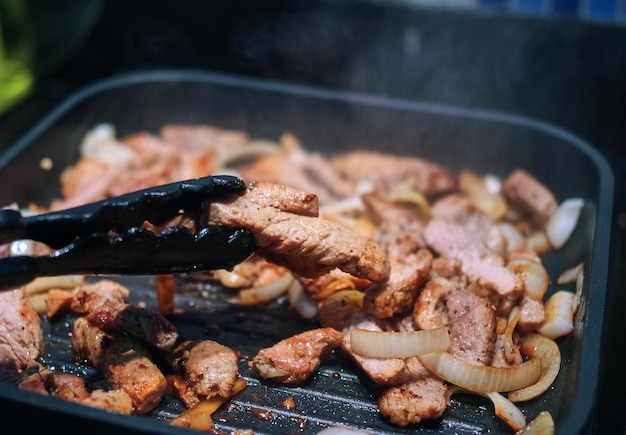 Meat grilling on the cooking pan