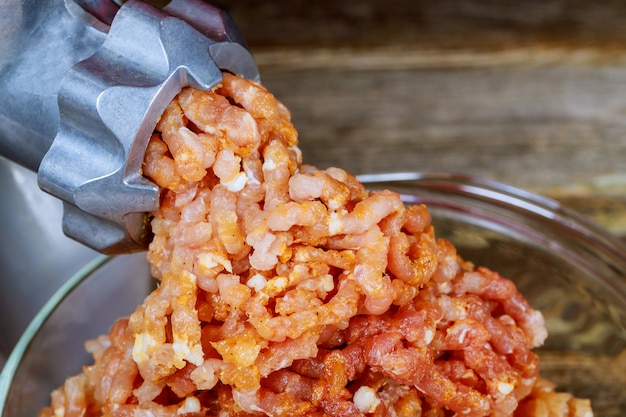 Meat grinder portion of Minced Meat on an old wooden table