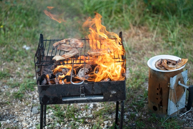 肉は野外条件で炎のグリルで揚げられます