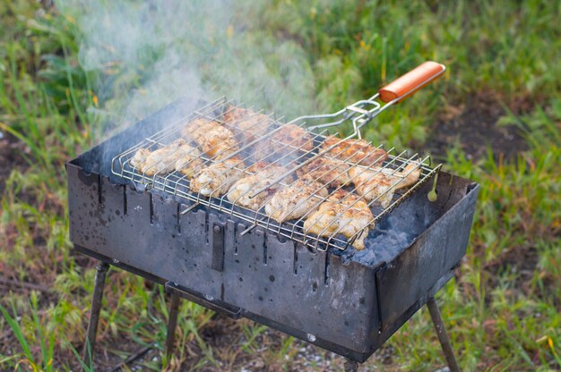 Meat is fried on a grid on the grill