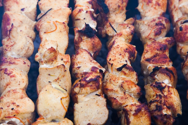 The meat is grilled on a grid over charcoal closeup