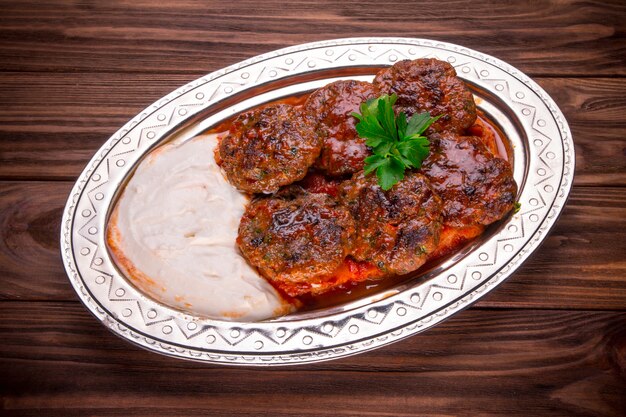 Meat kebab beef balls with sauce  on wooden table