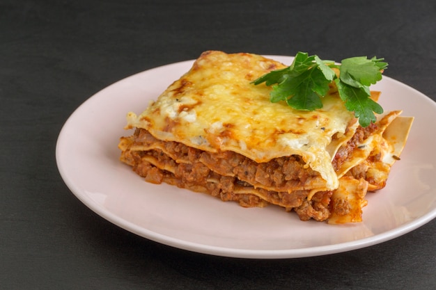 Meat lasagna on a wooden table.