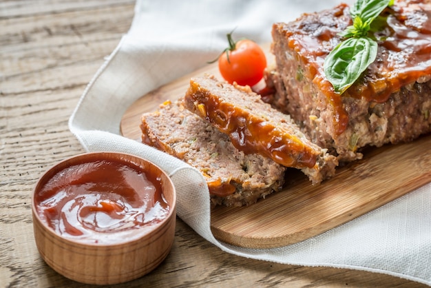 Meat loaf with barbecue sauce on the wooden board