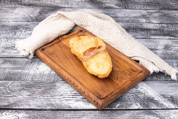 Meat pies on a white wooden background wooden plate