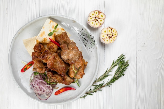 meat on pita bread with garlic on a wooden background