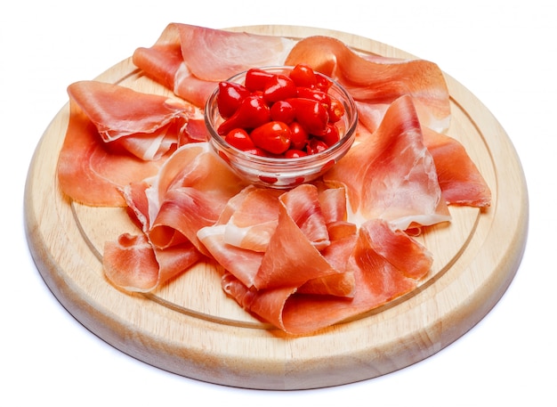 Photo meat plate of italian prosciutto crudo or spanish jamon on wooden cutting board