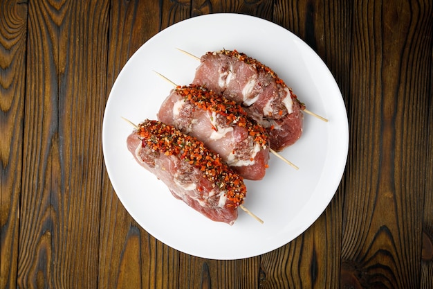 meat products on a white plate on a wooden table