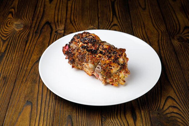 meat products on a white plate on a wooden table