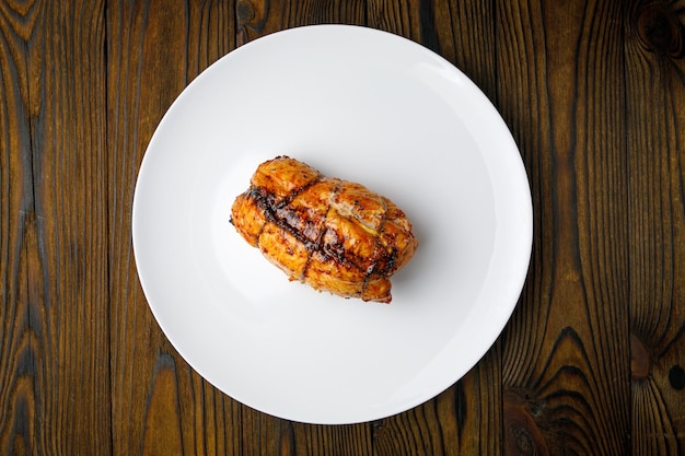 meat products on a white plate on a wooden table