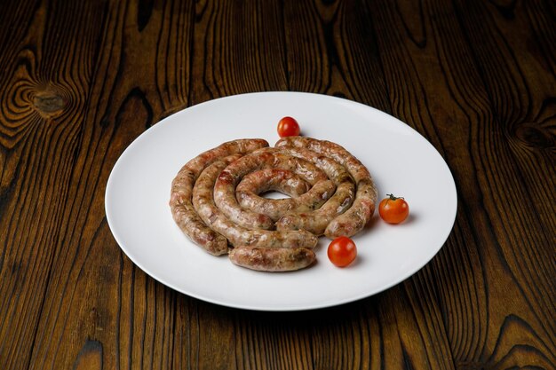 meat products on a white plate on a wooden table