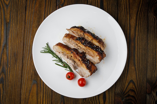 meat products on a white plate on a wooden table