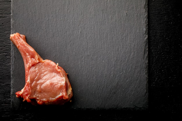 Meat Raw Fresh Mutton on the bone on a slate board 