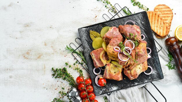 Meat Raw marinated kebab with onions and spices on a black plate Top view Free copy space