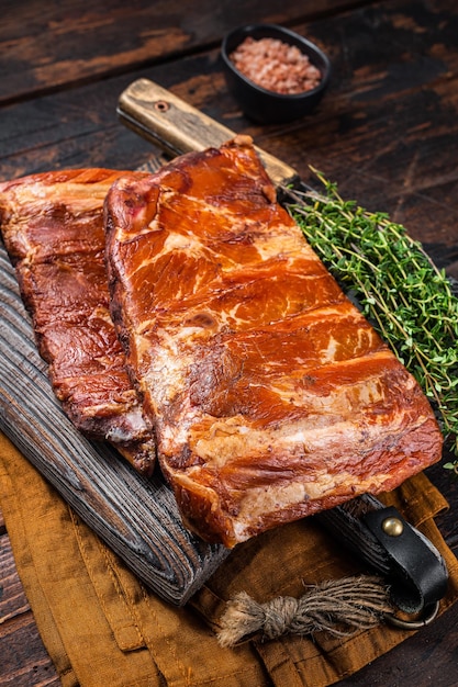 Meat restaurant kitchen Smoked BBQ Pork Ribs on wooden cutting board Wooden background Top view