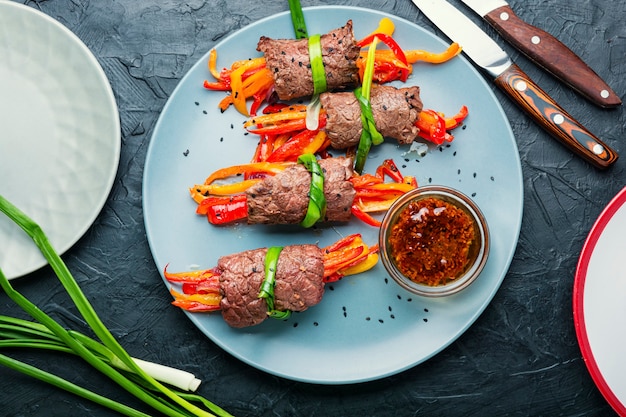 Meat rolls and vegetables on plate