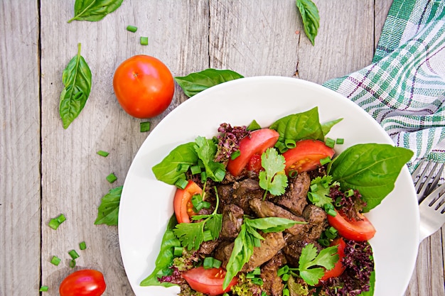 Meat salad with liver and fresh vegetables. Top view, Flat lay