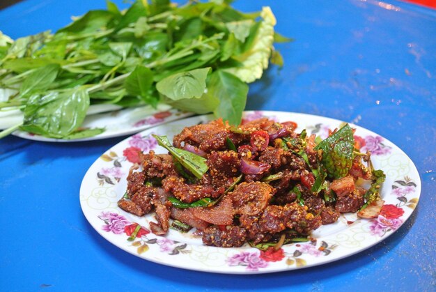 Photo meat served in plate on blue table