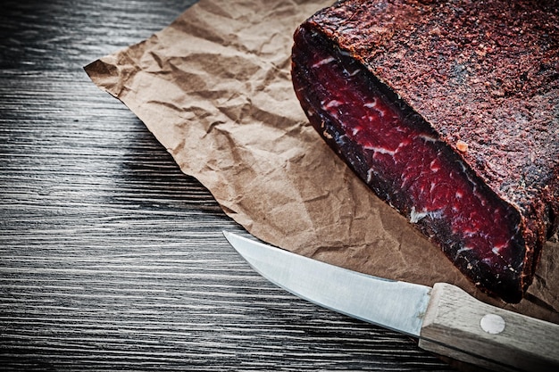 Meat shop paper knife on wooden board