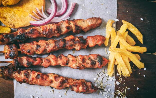 Meat skewers on a wooden background