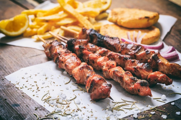 Meat skewers on a wooden background