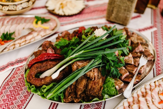 Meat slicing with delicious salami pieces of sliced ham meat\
pate meat platter with selection cold smoked meat plate with bacon\
pork top view