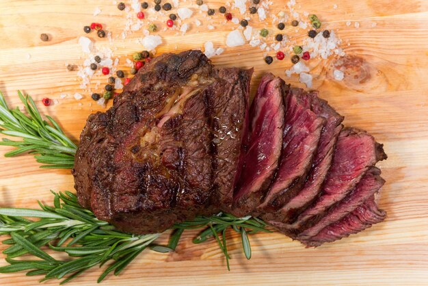 Meat steak and herbs on a wooden board